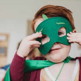 young child with green mask